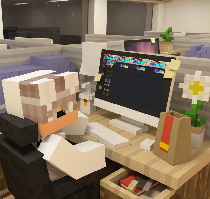 minecraft character sitting next to a desktop