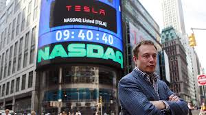 elon musk next to nasdaq sign