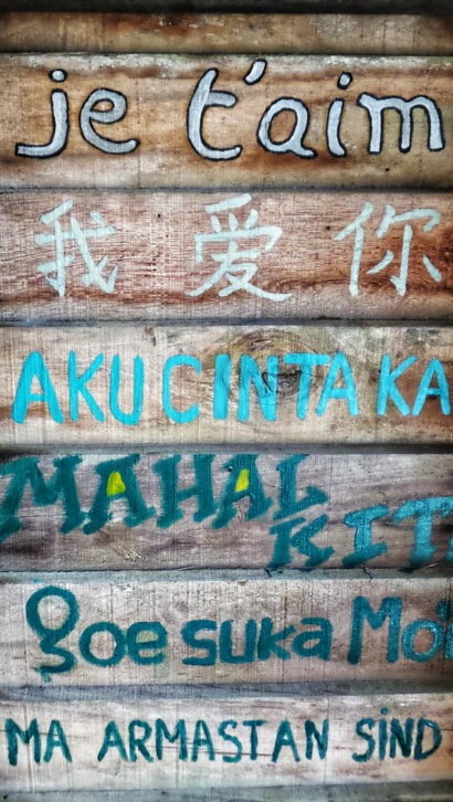 Several languages written on old wood