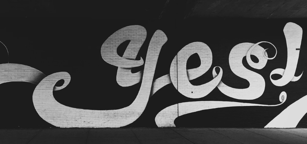 the word yes on a wall 