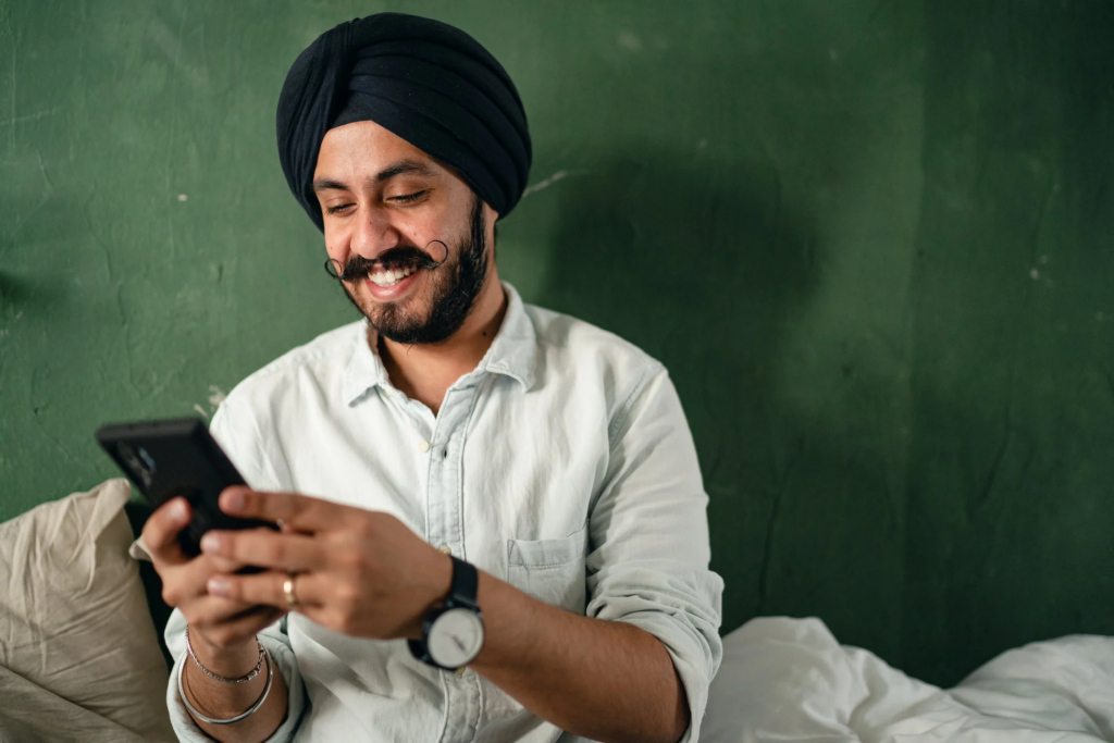 A Man Smiling Reading A Message